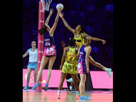 Jamaica’s goalkeeper Shamera Sterling (top right) goes high to defend ahead of Scotland goal shooter Emma Barrie (left), while Jamaica’s Adean Thomas (second left) and Lynsey Gallagher(GA) look on during their Vitaly Netball World Cup Group G game at t