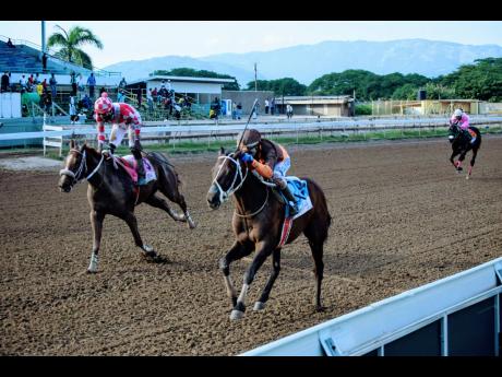 EROY, ridden by Oshane Nugent (right), wins the Pick 3 ‘Five Play Everyday’ Trophy ahead of FURTHER AND BEYOND (Linton Steadman), a three-year-old and Up Open Allowance Stakes over 7 1/2 furlongs at Caymanas Park, on Saturday. November 27, 2021.