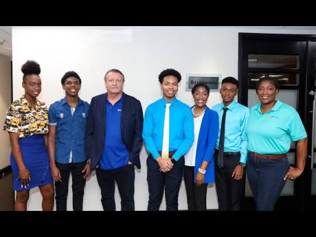 Credit: Contributed JWN Foundation Chairman JP Beyer (centre) and Chief Executive Officer Tanikie McClathy Allen (right), with scholars (from left) Martina Scarlett, Kyle Wilson, Malcolm Jarrett, Rhaveen Kildare, and Kevin Neil.