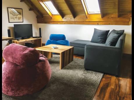 The lounge area is cosily situated right in the roof.