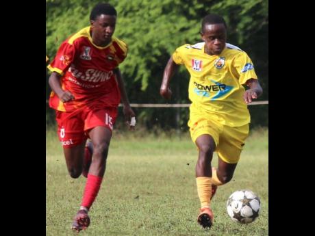 Garvey Maceo’s Christopher Mundle (right) outpaces Cornwall College’s Deshuan Talbert during their ISSA/Digicel Ben Francis Cup clash at Garvey Maceo today. Garvey Maceo won 3-1.