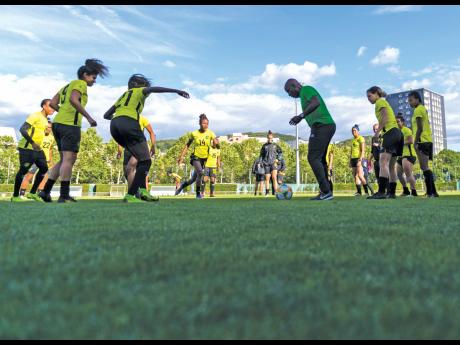 Lorne Donaldson (centre, right) the assistant coach at the FIFA Women’s World Cup  in 2019, joins Reggae Girlz  in training drills at a session at Stade Eugene Thenard in Grenoble, France on Sunday, June 16, 2019 ahead of the Group C match against Austra