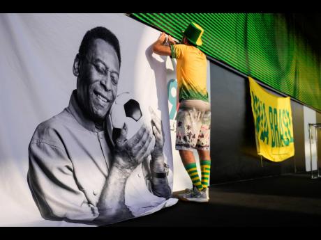 A fan displays a sign in support of Pelé at a Brazilian fan party before the World Cup round-of-16 match between Brazil and South Korea in Doha, Qatar, on December 5.