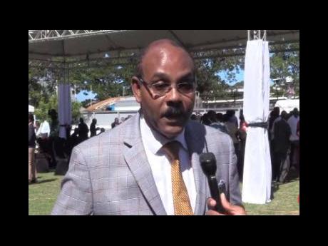 Prime Minister Gaston Browne speaks to reporters at the swearing-in ceremony of his new Cabinet.