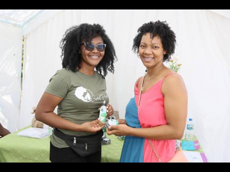 Nastassia Baker (left), CEO of CurlFrenz hair growth oil with Simone Spence-Johnson, president of the Manchester Chamber of Commerce, during the Made in Manchester expo held Sunday, March 26 at Scotiabank in Mandeville, Manchester.