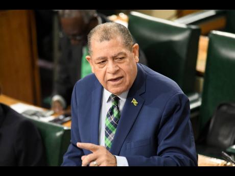 Audley Shaw, Minister of Transport and Mining, makes his presentation during the sectoral debate at the sitting of the House of Representatives at Gordon House yesterday.