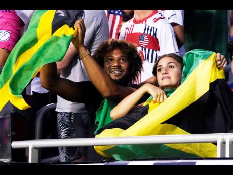 Jamaica fans wave flags during the first half of the team’s Concacaf Gold Cup match against the United States on Saturday, June 24  in Chicago. The game ended in a 1-1 draw.
