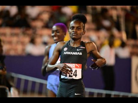 Nickisha Pryce eases at the finish line after winning her women's 400 metres semi-final at the National Senior and Junior Championships at the National Stadium tonight.