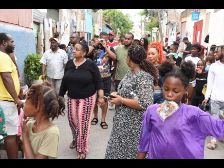 Credit: Ian Allen Members of Project STAR and social influencers walk along a section of Maiden Lane in Central Kingston where they chatted with residents on Tuesday while getting a first-hand look at what is happening in the communities in Central Kingston.