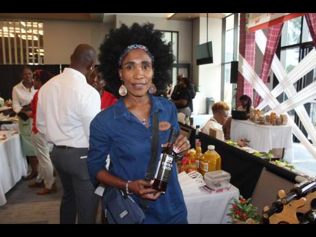 Donna-Kaye Sharpe displaying a bottle of Chocollor Chocolate ‘chocolate liqueur’ at the 2023 Christmas in July event.