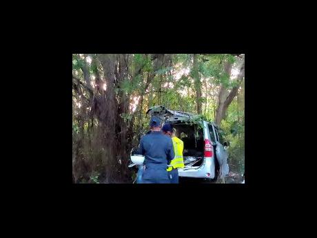 Credit: Contributed Police process the accident scene in Bluefields, Westmoreland, where five people died following a three-vehicle collision on Monday.