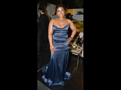 Lauren Duncan radiates joy, showcasing a beautiful mermaid silhouette in blue with a sweetheart neckline.