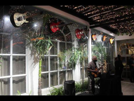 Stringed musical instruments adorning the eastern wall of Strings, a restaurant at Spanish Court Hotel in New Kingston.