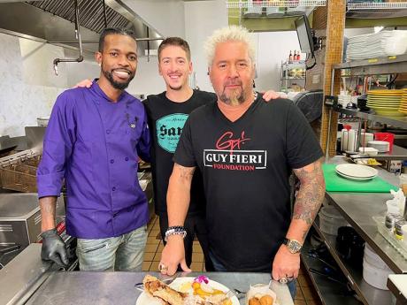 Chef Oniel Smith (left) behind the scenes during the filming of popular food show, ‘Diners, Drive-Ins, and Dives’, shares lens time with hosts, father-son duo Guy (right) and Hunter Fieri.