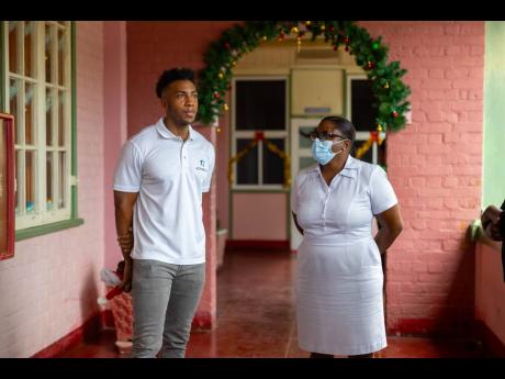  ActiveNest’s Managing Director Mikhail Russell converses with Nurse Edwards-Knight at the Bustamante Hospital for Children.