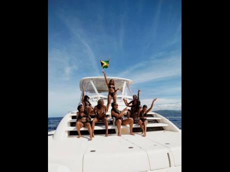 Credit: Contributed Adams and her girls bask in the island sun, making waves as Jamaican hotties on a yacht.