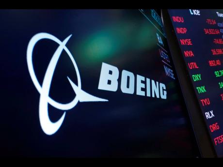 The logo for Boeing appears on a screen on the floor of the New York Stock Exchange.