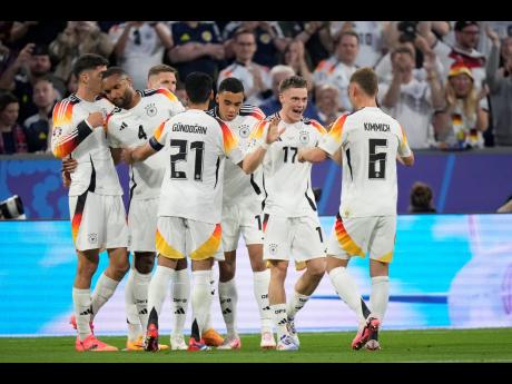 Credit: AP Germany’s Florian Wirtz (second right) celebrates with teammates after scoring his side’s opening goal during a Group A match between Germany and Scotland at the Euro 2024 soccer tournament in Munich, Germany yesterday. Germany won 5-1.