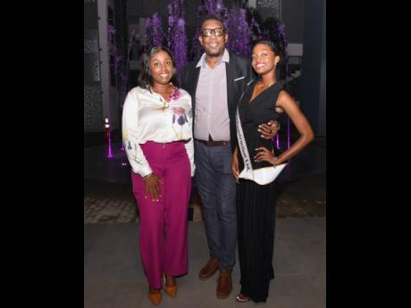Floyd Lewis, branch manager of Barita Investments-Fairview, is flanked by Sheraine Reid (left), marketing manager of Half Moon, and contestant Jolon Dewar.