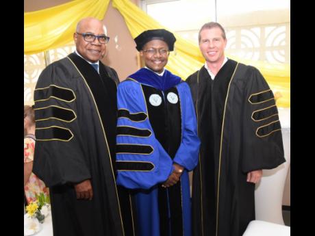 Professor Colin Gyles (centre) poses for pictures with Edmund Bartlett (left), minister of tourism, and Adam Stewart (right), executive chairman, Sandals Resorts International, Island Routes and the ATL Group and president of The Sandals Foundation. Bartle