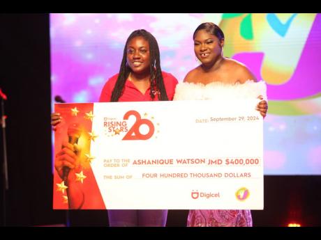 Sheryl Lampart, Digicel marketing executive, presents Ashanique Watson with her third-place prize of $400,000.
