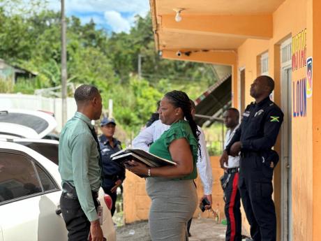Members of the Jamaica Constabulary Force (JCF) at the bar where a mass shooting occurred when armed men opened gunfire on patrons in New Roads in Westmoreland on Monday. Eight individuals were shot and four died.