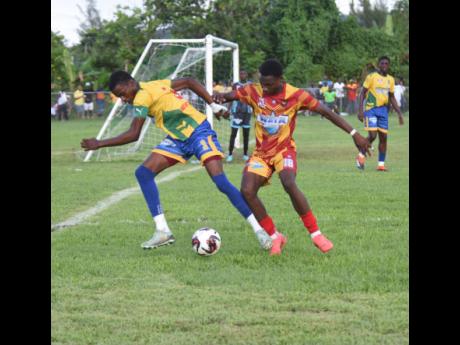 Credit: Ashley Anguin Rusea’s High School’s Andre Brown (left) competes with Cornwall College’s Andre Reynolds during their ISSA/WATA daCosta Cup match at the Collin Miller Sports Complex in Lucea yesterday.