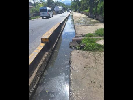 Water settles in a drain in Lucea, Hanover, last week.