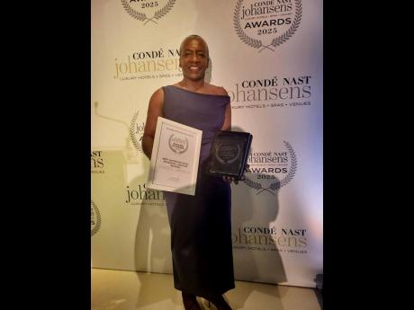S Hotel Jamaica’s UK representative Debbie Melchor poses with the Johansen’s Best Lakeside Hotel award in London.