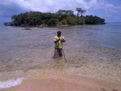 Gleaner writer Paul H. Williams returning on foot from Monkey Island, off the Folly coast in Portland. 