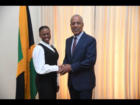 Aundrene Cameron, the 2025 Rhodes Scholar, is greeted by Professor Gordon Shirley, who is representing Governor General Sir Patrick Allen, at the announcement of the scholarship winner on Thursday at King’s House in St Andrew.