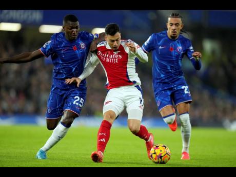 Chelsea’s Moises Caicedo (left) vies for the ball with Arsenal’s Gabriel Martinelli during an English Premier League football match at Stamford Bridge in London on November 10, 2021.