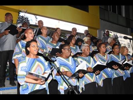 The National Chorale of Jamaica brings merriment to the audience on the steps of the Half-Way Tree, St Andrew branch at the JN Bank carolling event.