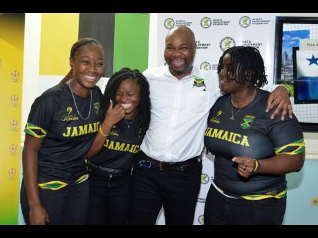 President of Jamaica Lacrosse Calbert Hutchinson (second right) with members of the Jamaica Lacrosse women’s team (from left)   Jhanae Bravo, Patricia Walters and Shannen Graham during a press conference at the Jamaica Olympic Association head office off