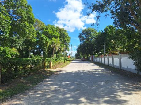 Credit: Photo by Rochelle Clayton The Fairfield Road in Irwin, St James, where several residents have received notices of land acquisition.