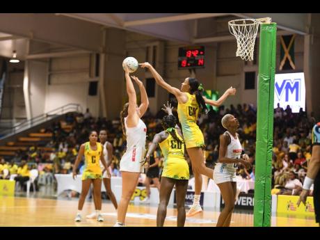 Credit: Antoine Lodge Sunshine Girls’ captain and goalkeeper Shamera Sterling Humphrey (second right) jumps to defend against the shot of South Africa SPAR Proteas’ goal shooter Elmere van der Berg during the Margaret Beckford Sunshine Series at the National Indoor Sports C