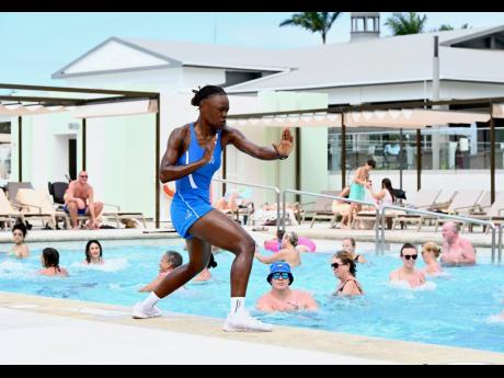 Shana Lee Gayle, fitness instructor guiding visitors though a fitness session in the pool at RIU Negril in Hanover on Friday.