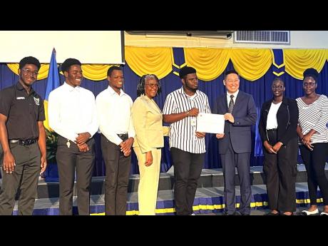 Chinese Ambassador to Jamaica Chen Daojiang (third right) recently presented scholarships to eight students studying science, technology, engineering and mathematics (STEM) programmes at Northern Caribbean University (NCU). He noted that the Chinese Ambass