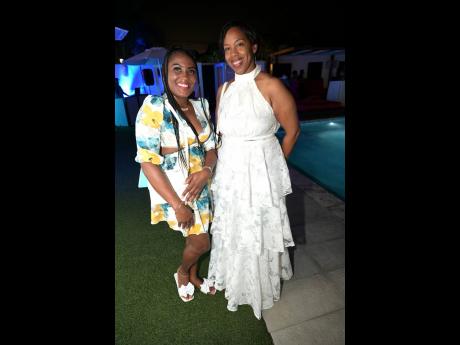 Sarnia Lewis-Raymond (right), assistant manager, marketing sales and strategy department at CUNA Caribbean Insurance, poses with Tiffany Smiley, account executive.