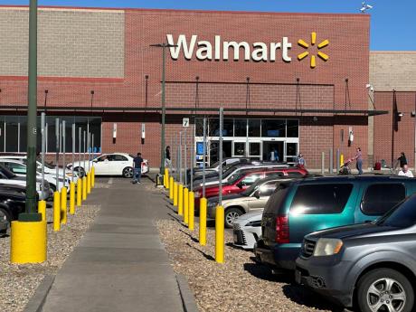 Shoppers head into and out of a Walmart store, in Englewood, Colorado recently.