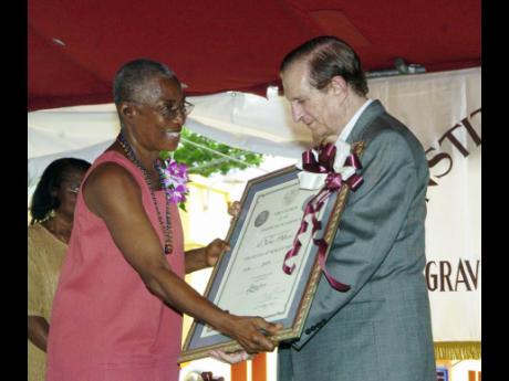 Credit: File Dr Velma Pollard accepts her Musgrave award for Literature from former Prime Minister Edward Seaga on East Street, Kingston in 2006.