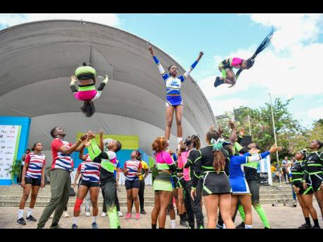 Credit: Matthew McKoy/Photographer A show of determination and flexibility is seen during a combined routine by cheerleading squads including the Swans, Moon Marshals, Lady Spade, Blu Lightning and CMU at the Sagicor Sigma Run 2025 held in New Kingston yesterday.