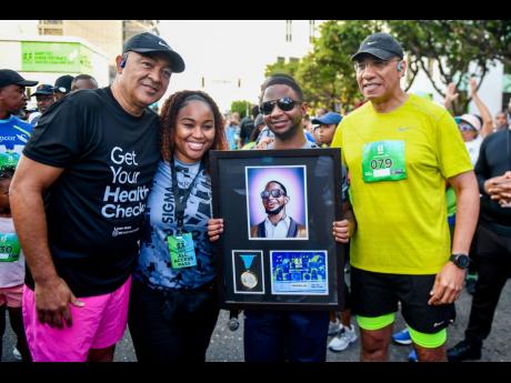 Credit: Matthew McKoy/Photographer Health Minister Dr Christopher Tufton(left) and Prime Minister Dr Andrew Holness (right) with musical artiste Nigel ‘Nigy Boy’ Hector and his Sagicor supporter at the Sagicor Sigma Run 2025 held in New Kingston yesterday.