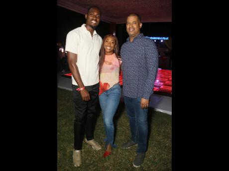 Credit: Nathaniel Stewart Olympians and Grace Foods ambassadors Hansle Parchment (left) and Shelly-Ann Fraser-Pryce (centre), and Frank James, chief executive officer, GraceKennedy Limited, share a moment before the event’s proceedings.