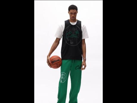 Credit: Contributed The SAINT star in a Boston Celtics sports jersey and snap pants.