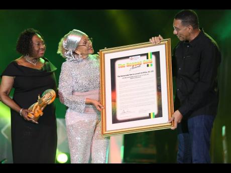 Credit: Nathaniel Stewart Prime Minister Dr Andrew Holness presents Marcia Griffiths with The Lifetime Acheivement Awards during The Reggae Gold Awards Ceremony held on Friday, February 28 at the National Indoor Centre, Kingston. Minister of Culture, Gender, Entertainment and Sport
