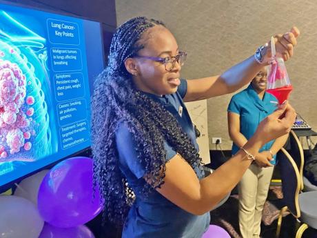 Makita Garrick, of Purple Team, demonstrates how lung cancer affects the body, during the Moon Palace Foundation’s Cancer Awareness Expo and Competition.