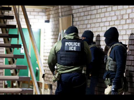 Credit: AP United States Immigration and Customs Enforcement officers wait to detain a person on January 27 in Silver Spring, Maryland.