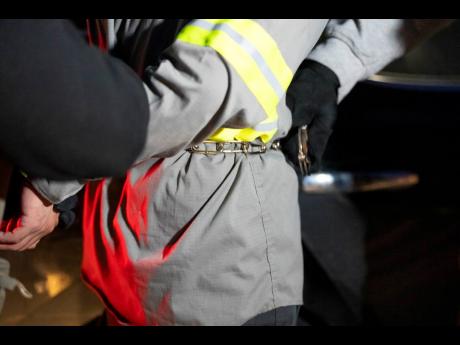 Credit: AP US Immigration and Customs Enforcement officers detain someone during an enforcement operation on January 27 in Silver Spring, Maryland.