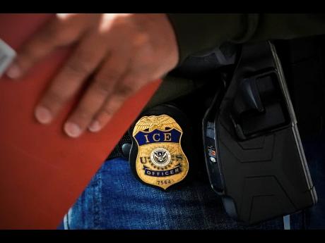 Credit: AP A deportation officer with US Immigration and Customs Enforcement conducts a brief before an early morning operation on December 17 last year in the Bronx borough of New York.